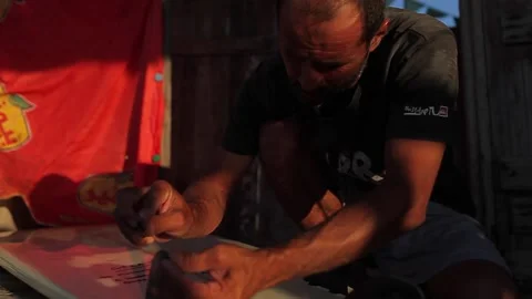 Man fixing the surfboard Stock Footage 148620872