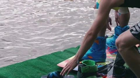 Man fixing wakeboard bindings Stock Footage 71756449
