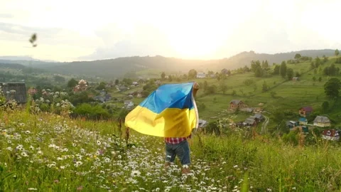 A man with the flag of Ukraine on the background of mountains. Stock Footage 171242183