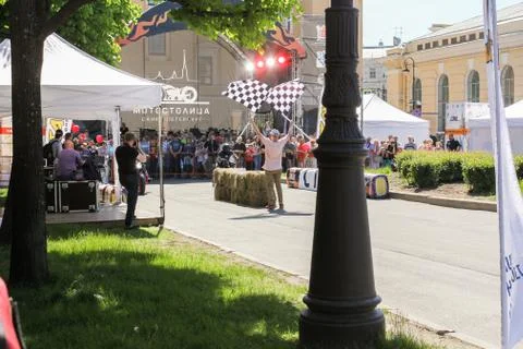 Man with flags on start. Stock Photos