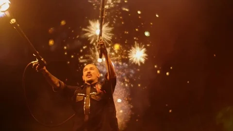 Man with a flamethrower on the background of a salute Stock Footage