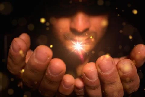 Man with a flash of magic light in his hands Stock Photos