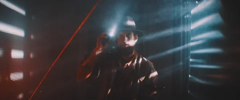 Man flashing flashlight towards camera in lights of shutters Stock Footage 203566253