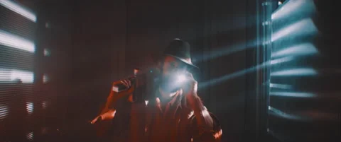 Man flashing flashlight towards camera in lights of shutters Video stock 203566526