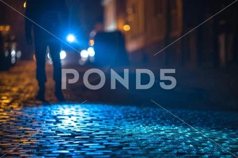 The man with a flashlight inspect the road. Evening night time Stock Photos