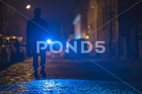 The man with a flashlight inspect the road. Evening night time Stock Photos