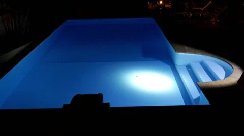 Man with Flashlight Inspects Pool at Night. Stock Footage 40648362