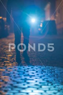 The man with a flashlight stand on the road. Evening night time Stock Photos