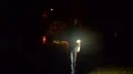 The man with a flashlight walking on the road. night time. anamorphic lens shot 4k or 4k+ Resolution