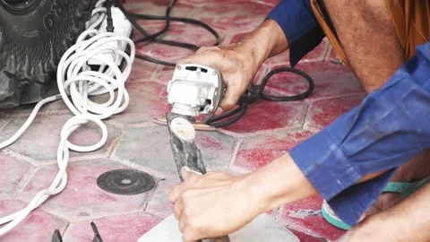 A man is flattening iron using a welding machine Stock Footage 303021505