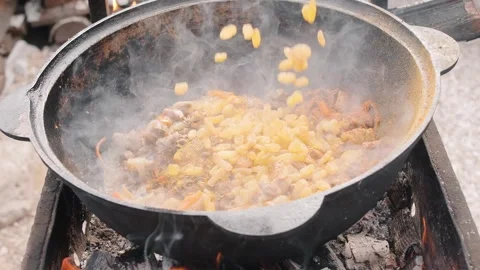 Man flavoring rice mixed with meat and vegetables in bowl Video stock 248044488