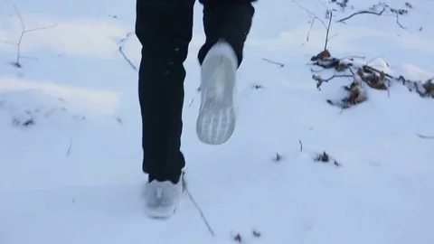 Man flees from persecution winter park. The footsteps Stockbeeldmateriaal 77035627