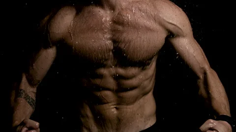 Man Flexing Abs and Chest Muscles as Rain Falls on Him Stock Footage 270315395