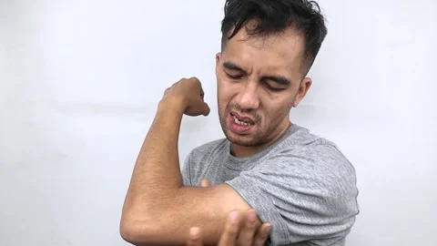 Man Flexing Bicep Muscle in Studio, Showing Strength and Determination. Stock Footage 315438744