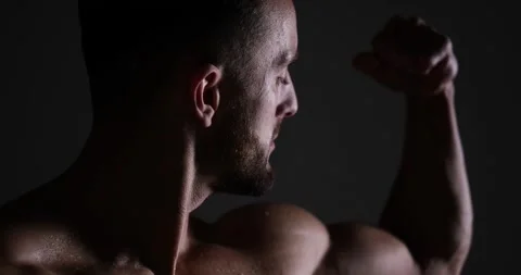 Man flexing biceps in studio Video stock 150141273