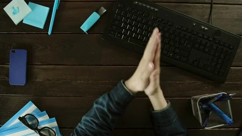 A man flexing his hands and typing on the keyboard on the computer. Stock Footage 82001254