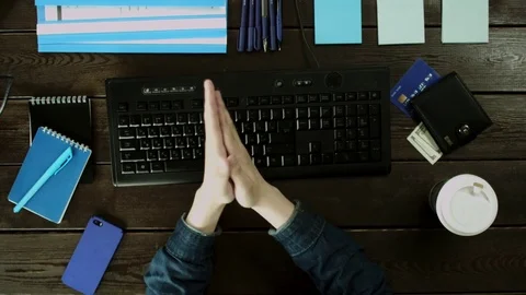 A man flexing his hands and typing on the keyboard on the computer. Stock Footage 82013006