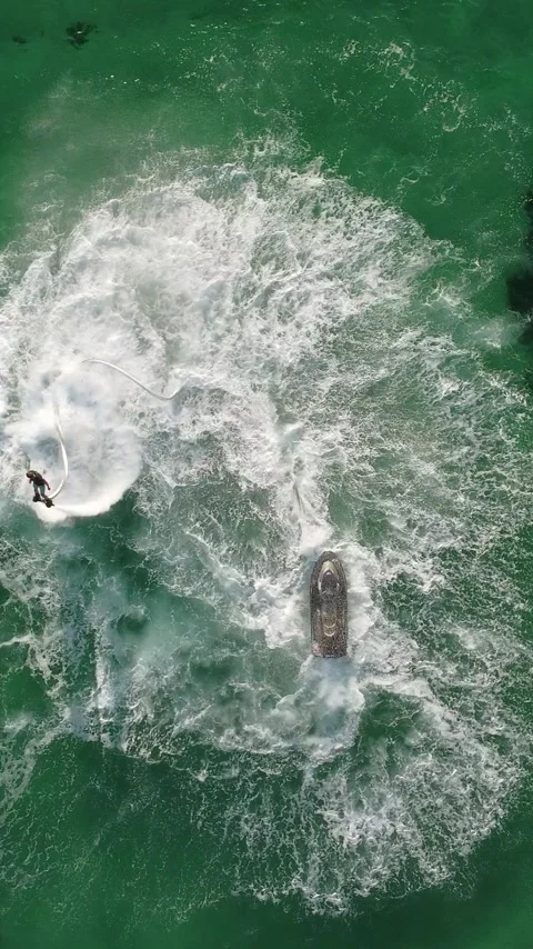 A man flies on a FlyBoard. Aerial top down view. Water extreme sport, azure Stock Footage 281861520