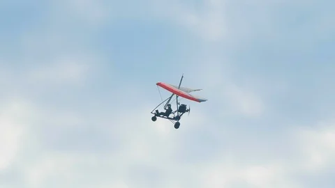 Man flies on multi-colored air bike with a motor through the sky in slow motion. Video stock 120585335