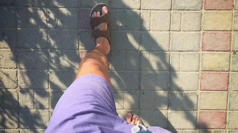 The man in flip flops walking along a track (slow motion) Video stock 64603918
