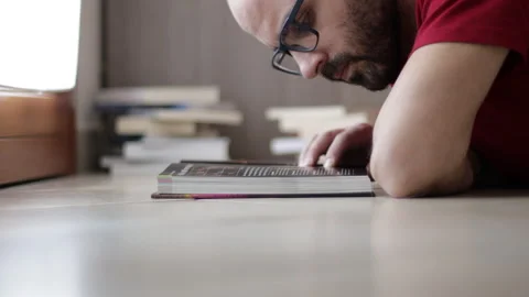Man Flipping Book Pages During Reading. Close Up shot. Boy Reading Book Stock Footage 149593961