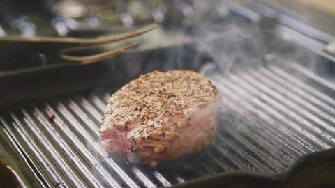 Man Flipping Fillet Steak With Fork In Kitchen Stock Footage 86071046