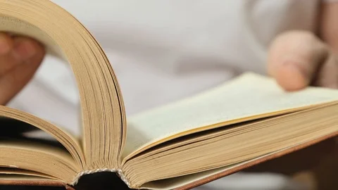 Man flipping pages in book for browsing. Close up. Stock Footage 125053075