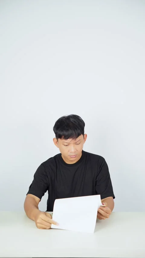 Man Flipping Through Documents on White Background Video stock 347105061