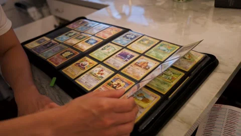 Man Flipping Through Old Pokemon Binder – Nostalgic Card Collection Video stock 248027059