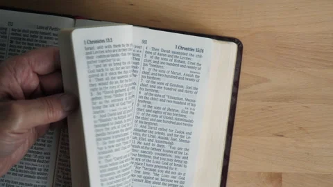 A man flipping through pages of the Bible Stock Footage 217476953