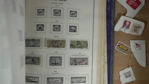 A man flipping through pages of a postage stamp collection Stock Footage 222973262