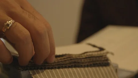 Man Flipping Through Pattern Samples For Suit Stock Footage 118095722