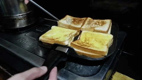 Man flipping a toast bread on flat pan with spatula Video stock 278509862