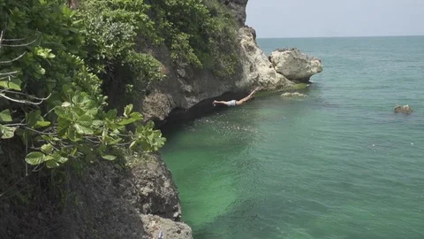 Man Flips Off Cliff in Bali Slow Motion Stock Footage 106783787