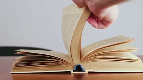 The Man Flips Through an Old Book. Slow Motion. Video stock 60703501