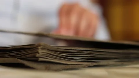 Man flips through the pages of an old album and looks through photographs. Stock Footage 141954852