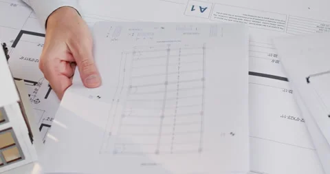 Man flips through stack of sketches and pauses at guest room Stock Footage 314730125