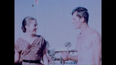 Man flirts with a girl at a Nevada Poolside resort, 1953 Stock Footage 125836670