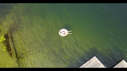 Man Floating on beautiful lake Stock Footage