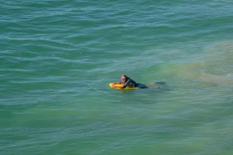 Man floating on a boogie board Stock Photos