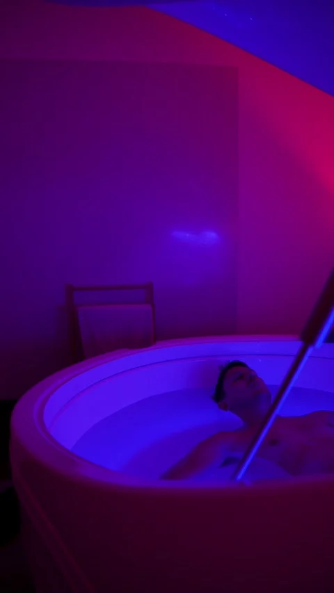 Man Floating in Hyper Saline Float Tank Pod Stock Footage 331335201