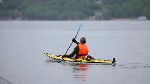 Man floating in a kayak on the river Stock Footage 76276223