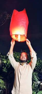 Man floating sky lantern Stock Photos