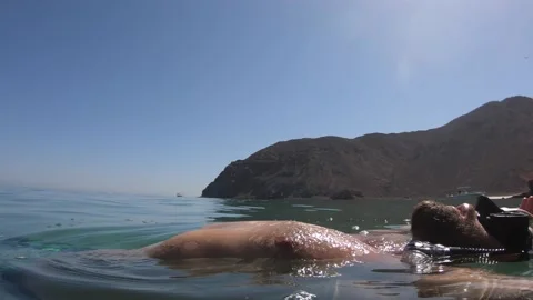 Man floating in the water Stock Footage 142309458