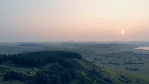 Man floats with a glider on a sunset background in sky. Paragliding, action Stock Footage 115201379