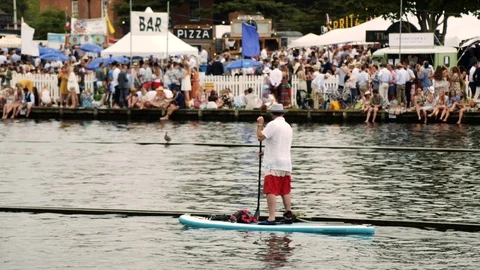 Man floats on paddle board down river Stock Footage 114063335