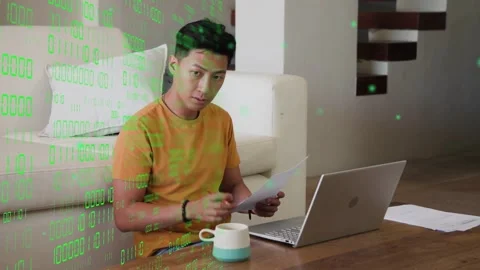Man on floor scanning docs penciling bringing page to PC entering IT-data green Stock Footage 334202578