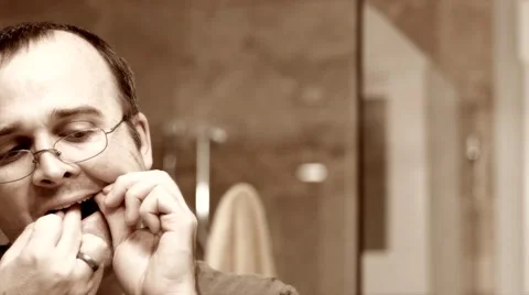 Man flosses his teeth Stock Footage 46765142