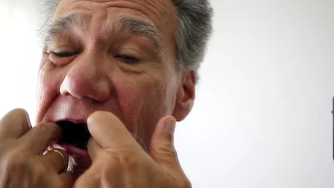 Man Flossing his Teeth Stock Footage 169544374