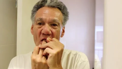 Man Flossing his Teeth Stock Footage 169544418